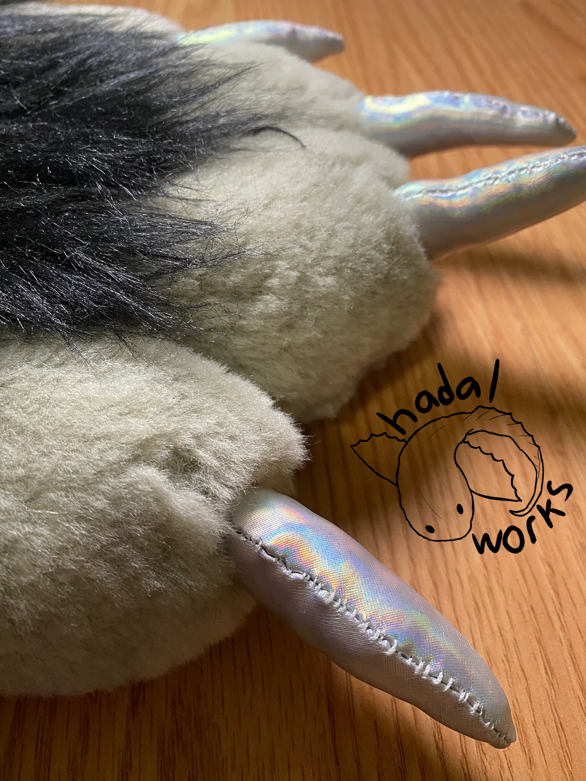 A closer look at the claws, showing their white stitching.