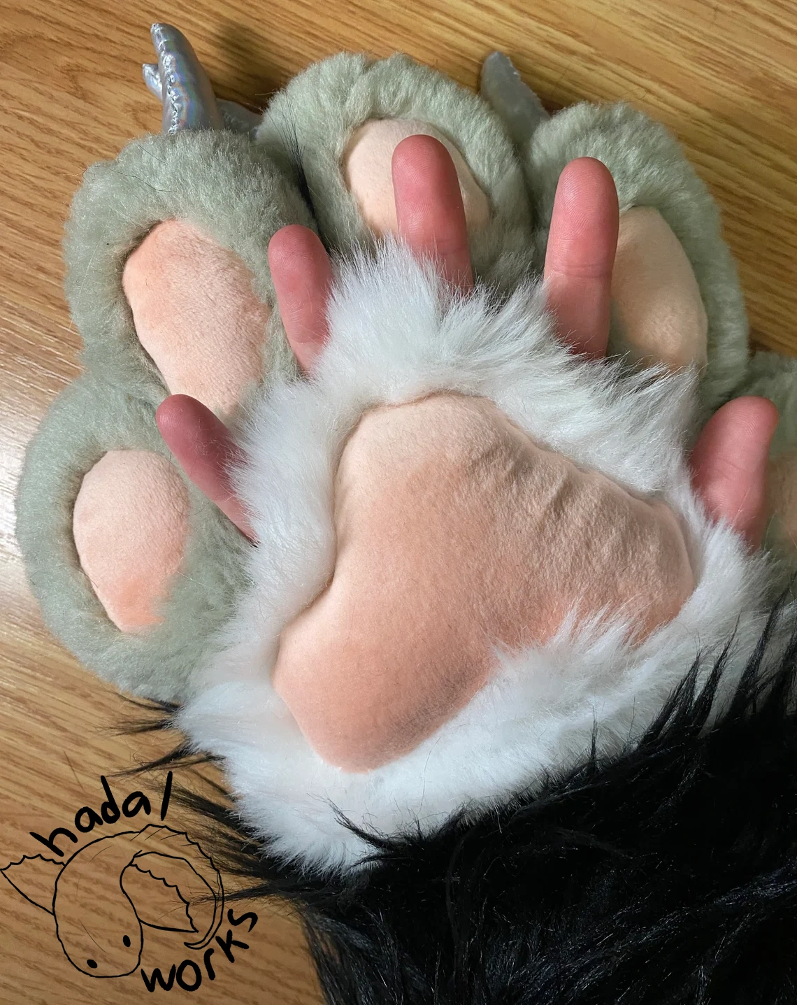 My fingers poking out of the hidden finger holes at the base of the paw's fingers.